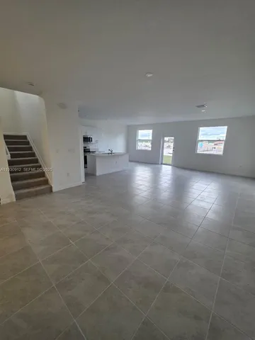 a view of an empty room with windows