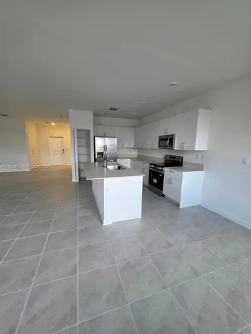 a large kitchen with cabinets and stainless steel appliances