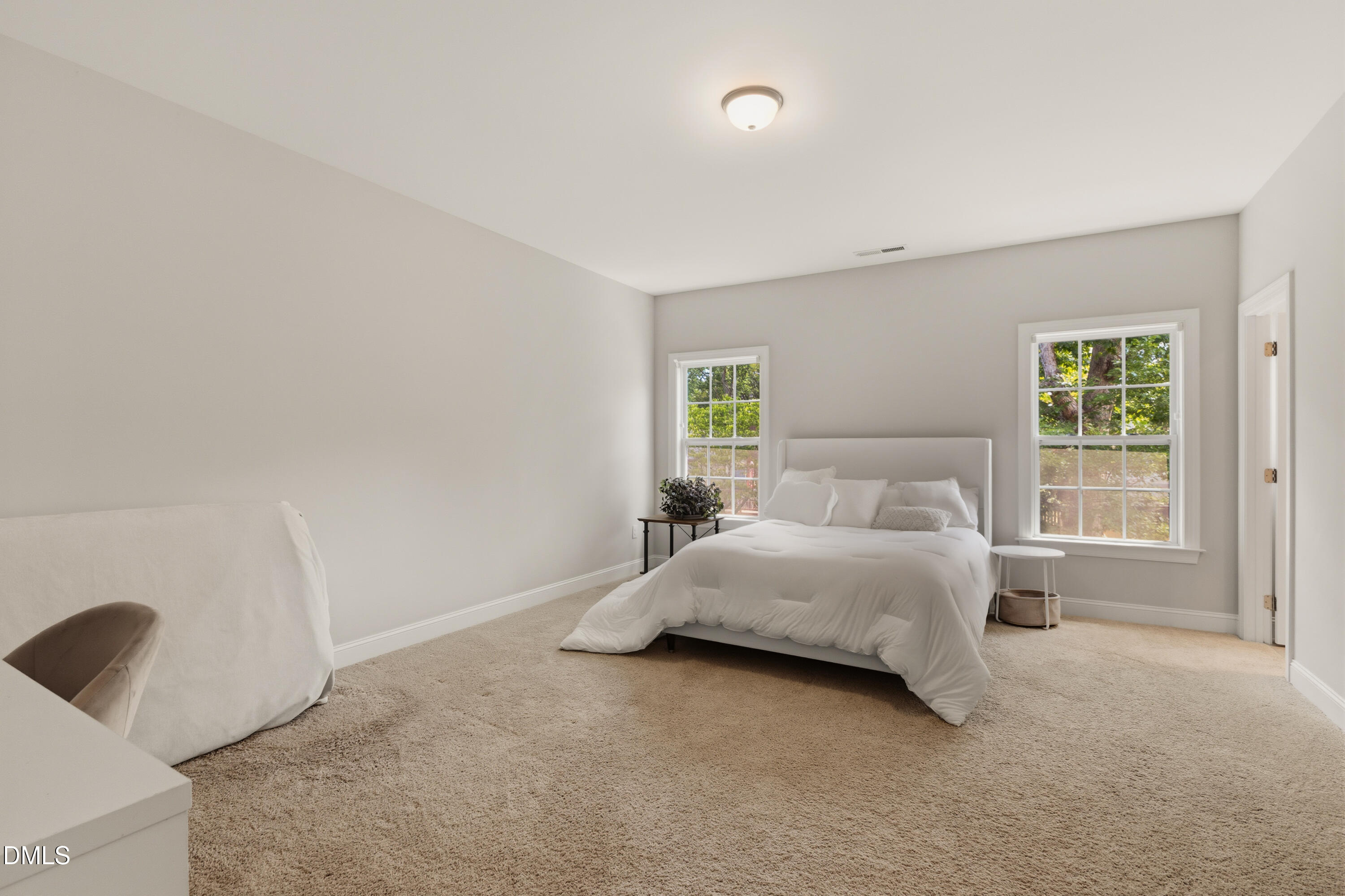 7421 Stonehenge Farm Lane Raleigh, NC 27613 - Photo 20 of 48 a spacious bedroom with a bed and a window