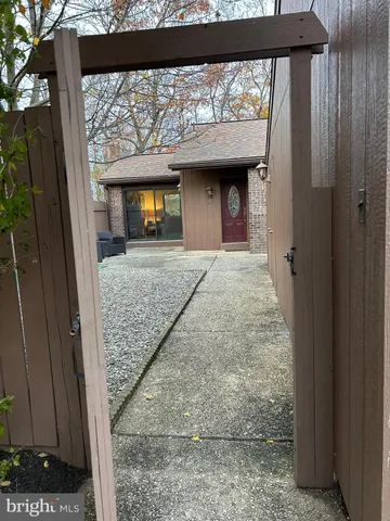 a view of porch with a floor to ceiling window and wooden floor