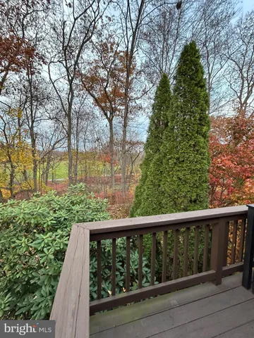 a view of a balcony with wooden floor and fence
