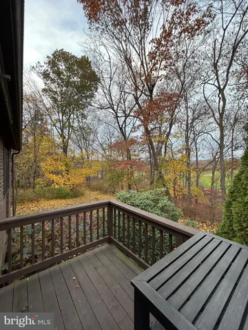 a view of balcony with wooden floor and fence