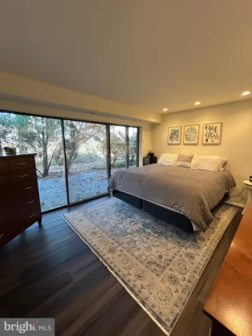 a bedroom with a bed and large window