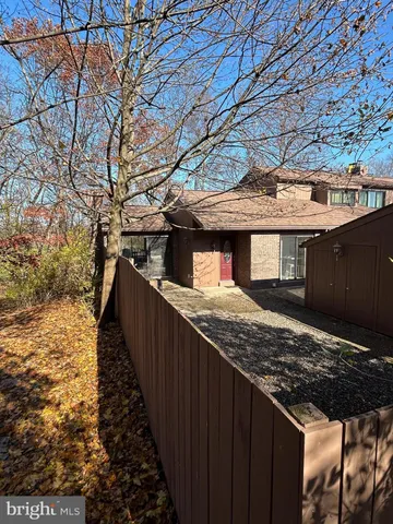 a view of a backyard with wooden fence