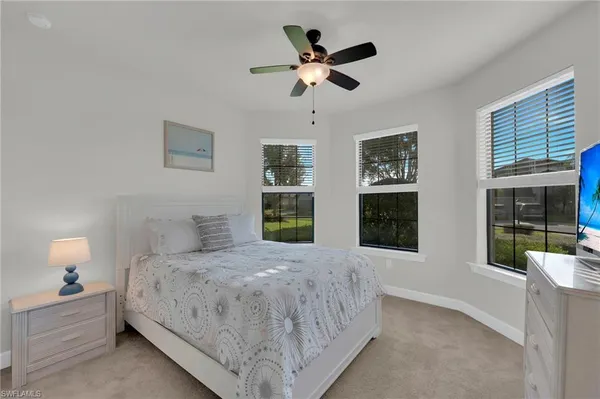 a bedroom with a large bed closet and window
