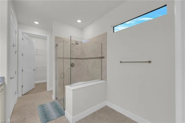 a bathroom with a shower and closet