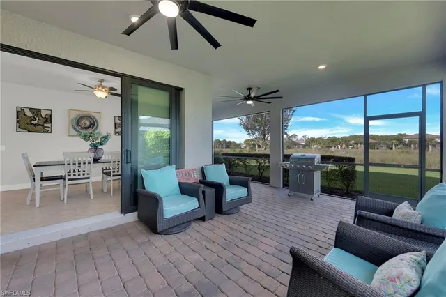 a living room with furniture and a view of kitchen