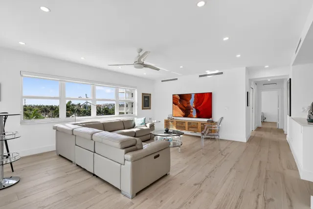 a kitchen with stainless steel appliances white cabinets and wooden floors