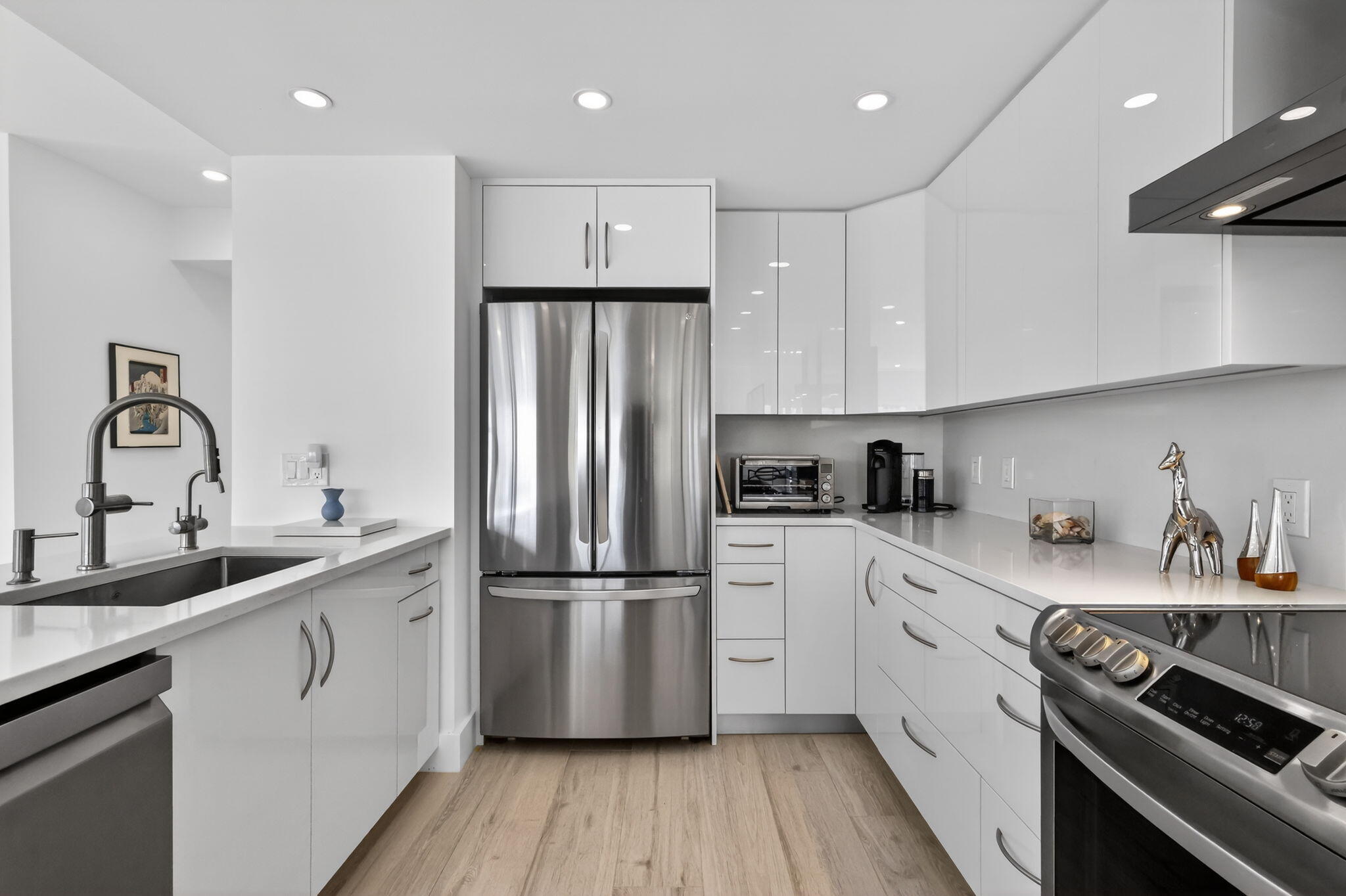 1000 Lowry Street, Unit 6J Delray Beach, FL 33483 - Photo 16 of 63 a kitchen with a sink appliances and cabinets