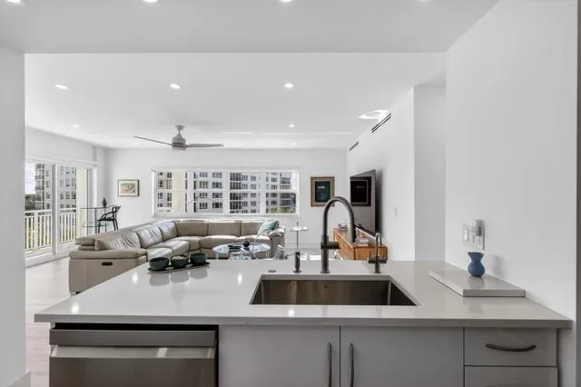 a kitchen with kitchen island a dining table and chairs