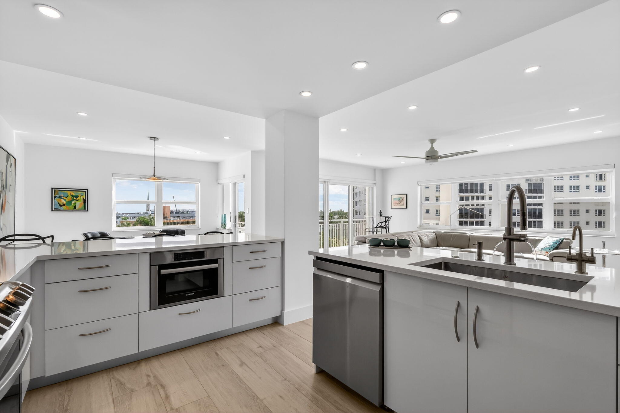 1000 Lowry Street, Unit 6J Delray Beach, FL 33483 - Photo 19 of 63 a kitchen with stainless steel appliances granite countertop a sink and stove