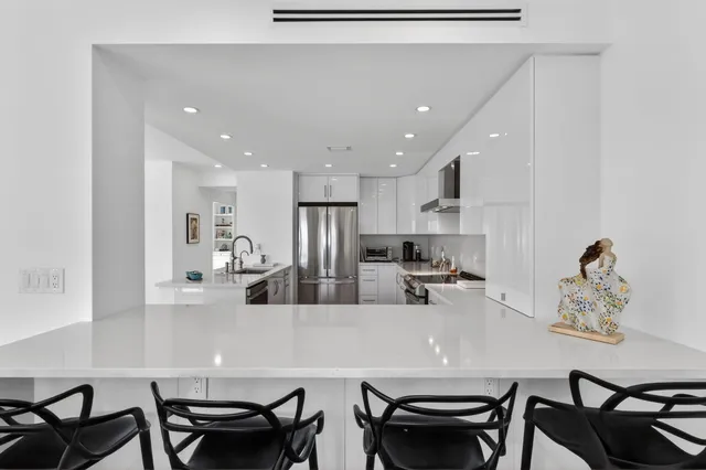 a view of a dining room with furniture and a chandelier
