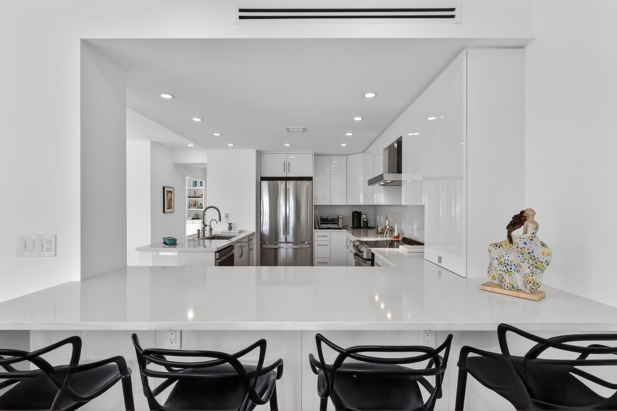 1000 Lowry Street, Unit 6J Delray Beach, FL 33483 - Photo 21 of 63 a kitchen with kitchen island a dining table and chairs