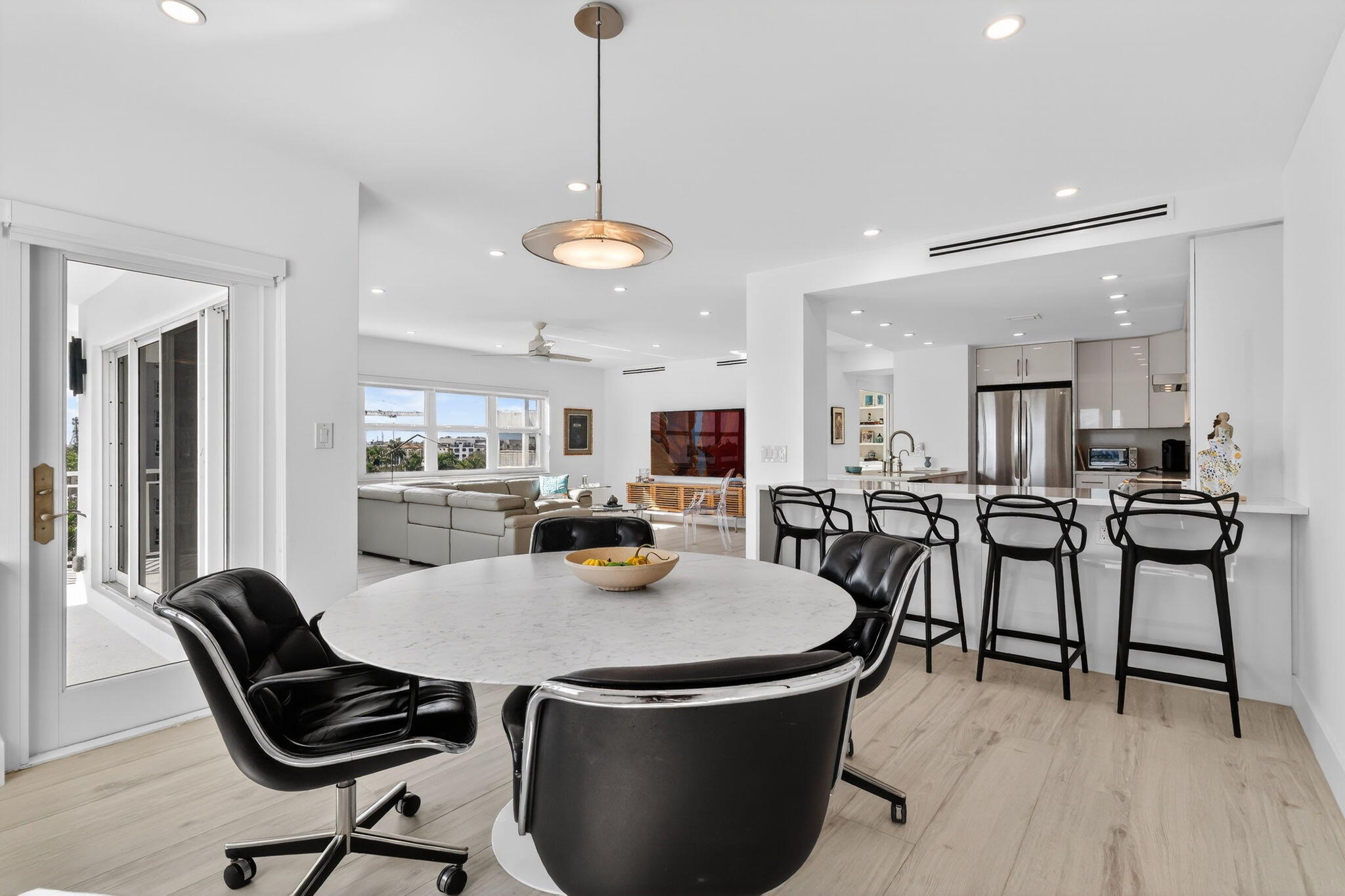 1000 Lowry Street, Unit 6J Delray Beach, FL 33483 - Photo 24 of 63 a dining room with furniture and wooden floor