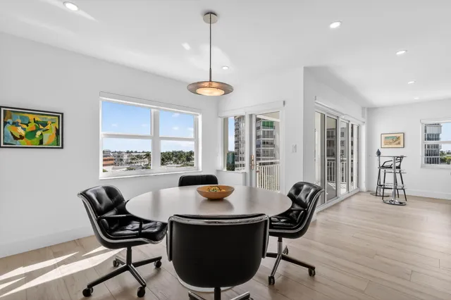 a living room with furniture and a floor to ceiling window
