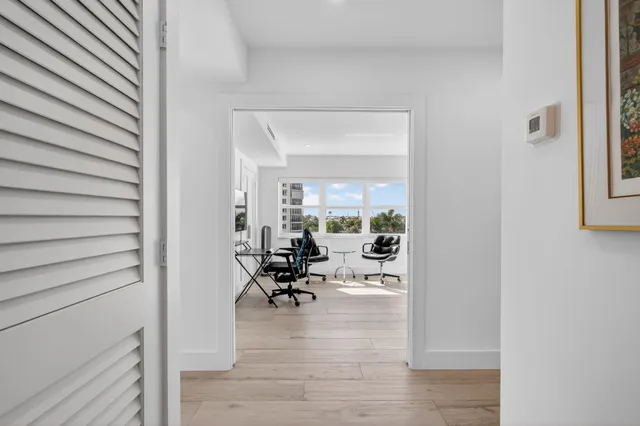 a view of a workspace with furniture and a window