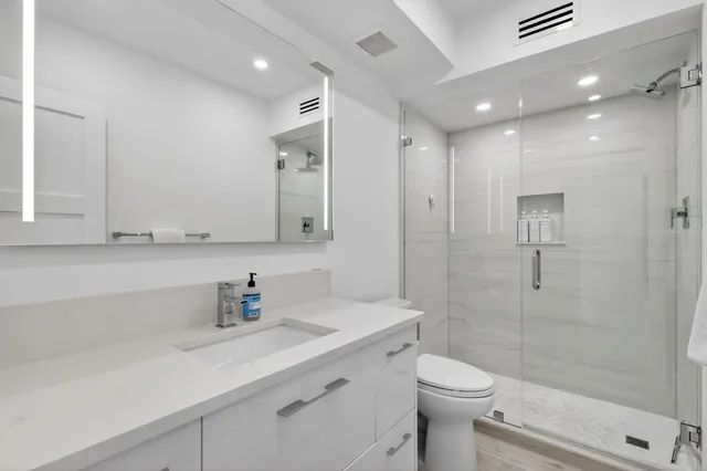 a bathroom with a sink toilet and shower