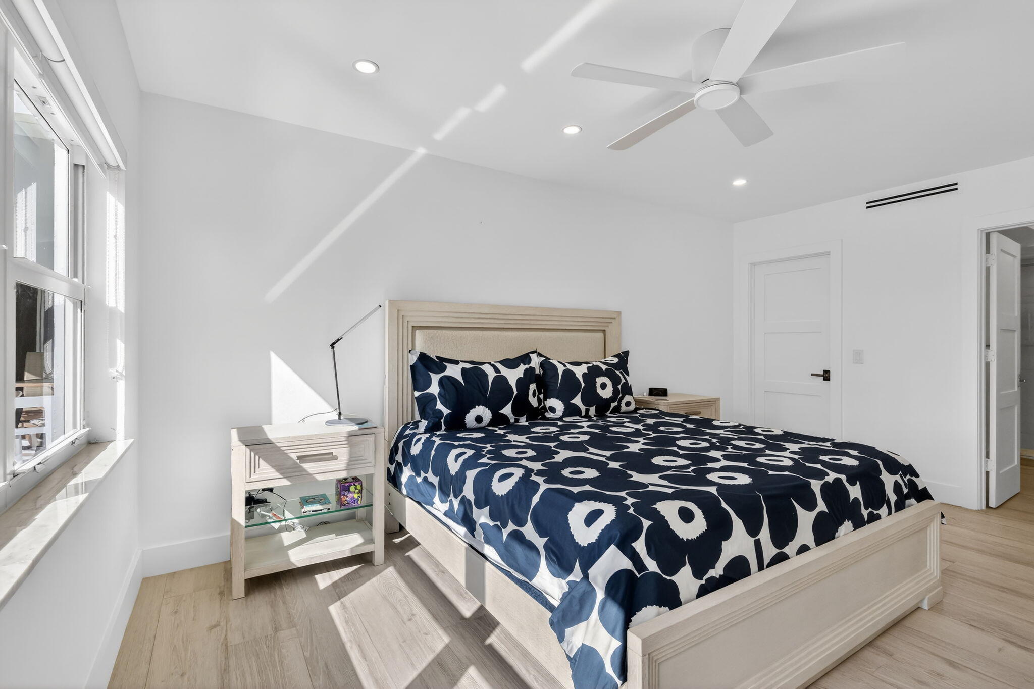 1000 Lowry Street, Unit 6J Delray Beach, FL 33483 - Photo 37 of 63 a bedroom with a bed and wooden floor