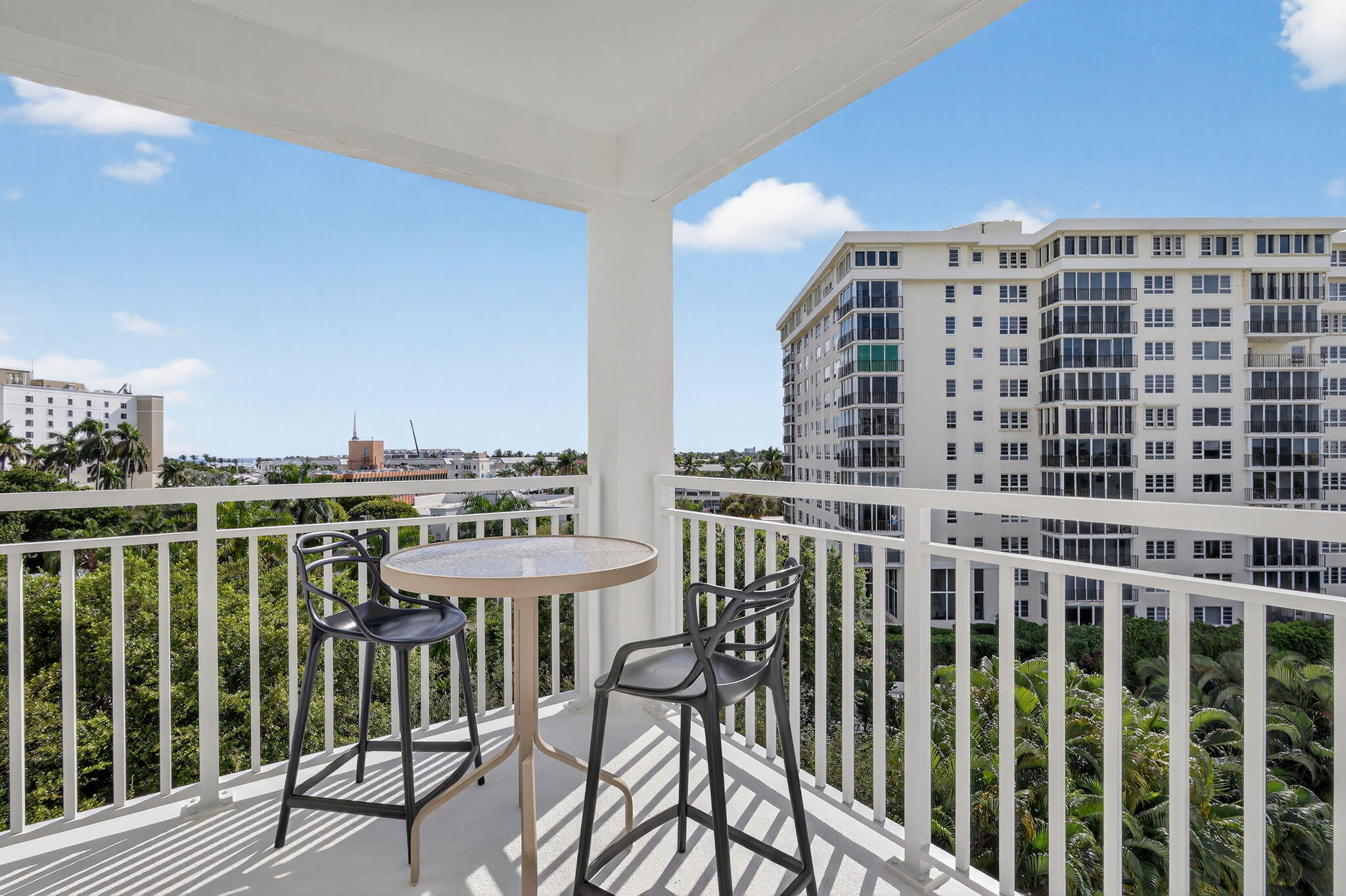 1000 Lowry Street, Unit 6J Delray Beach, FL 33483 - Photo 47 of 63 a view of a balcony with table and chairs