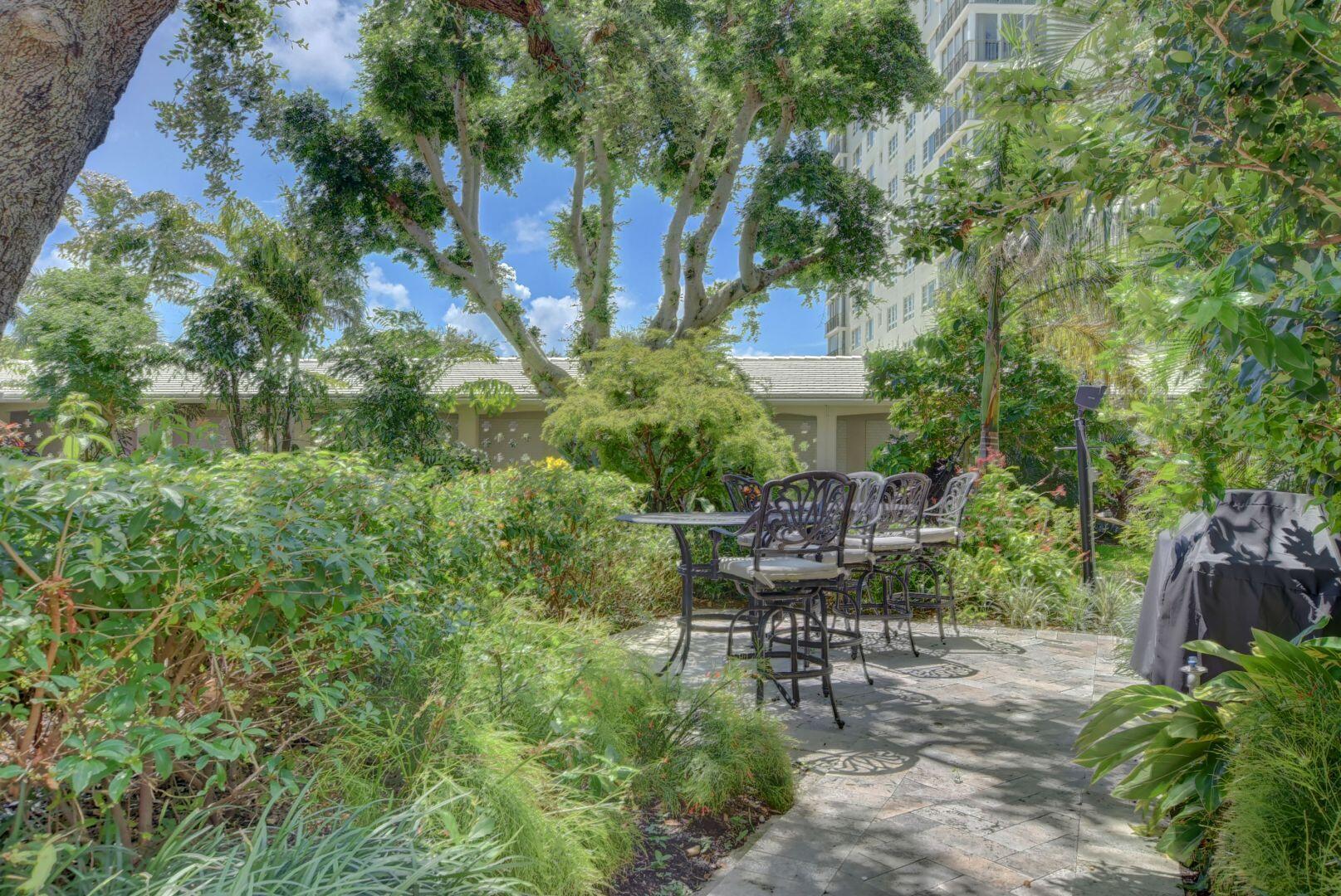 1000 Lowry Street, Unit 6J Delray Beach, FL 33483 - Photo 54 of 63 a view of a chair and table in the garden