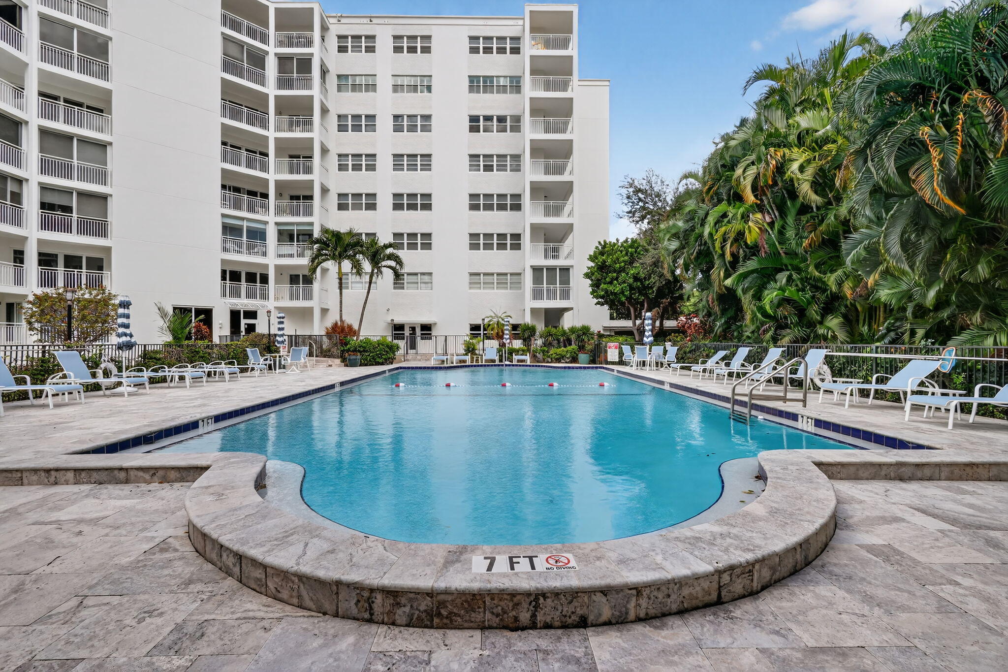 1000 Lowry Street, Unit 6J Delray Beach, FL 33483 - Photo 60 of 63 a view of a swimming pool with a lounge chair