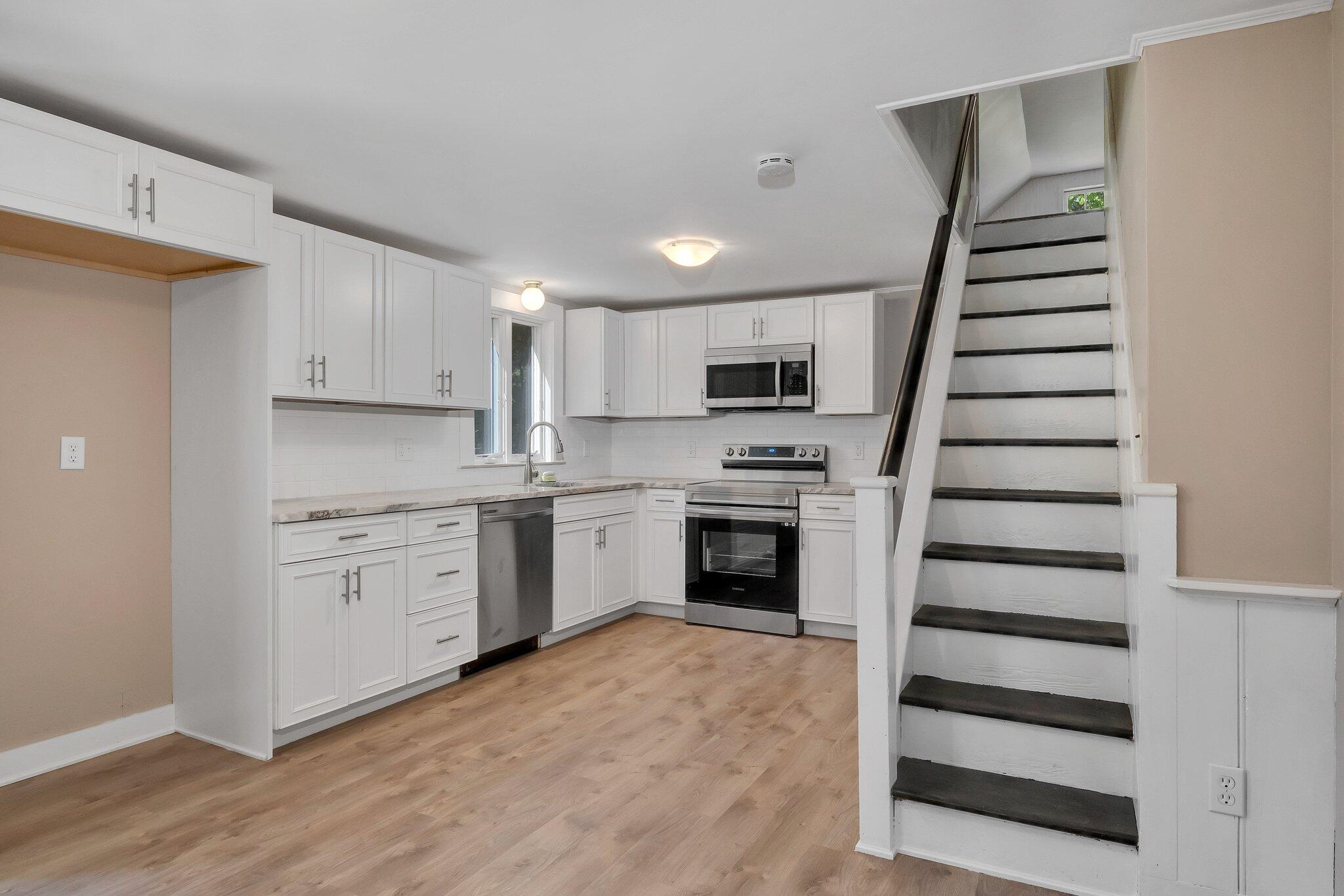 107 Chatham Road Harwich, MA 02645 - Photo 6 of 29 a kitchen with white cabinets and appliances