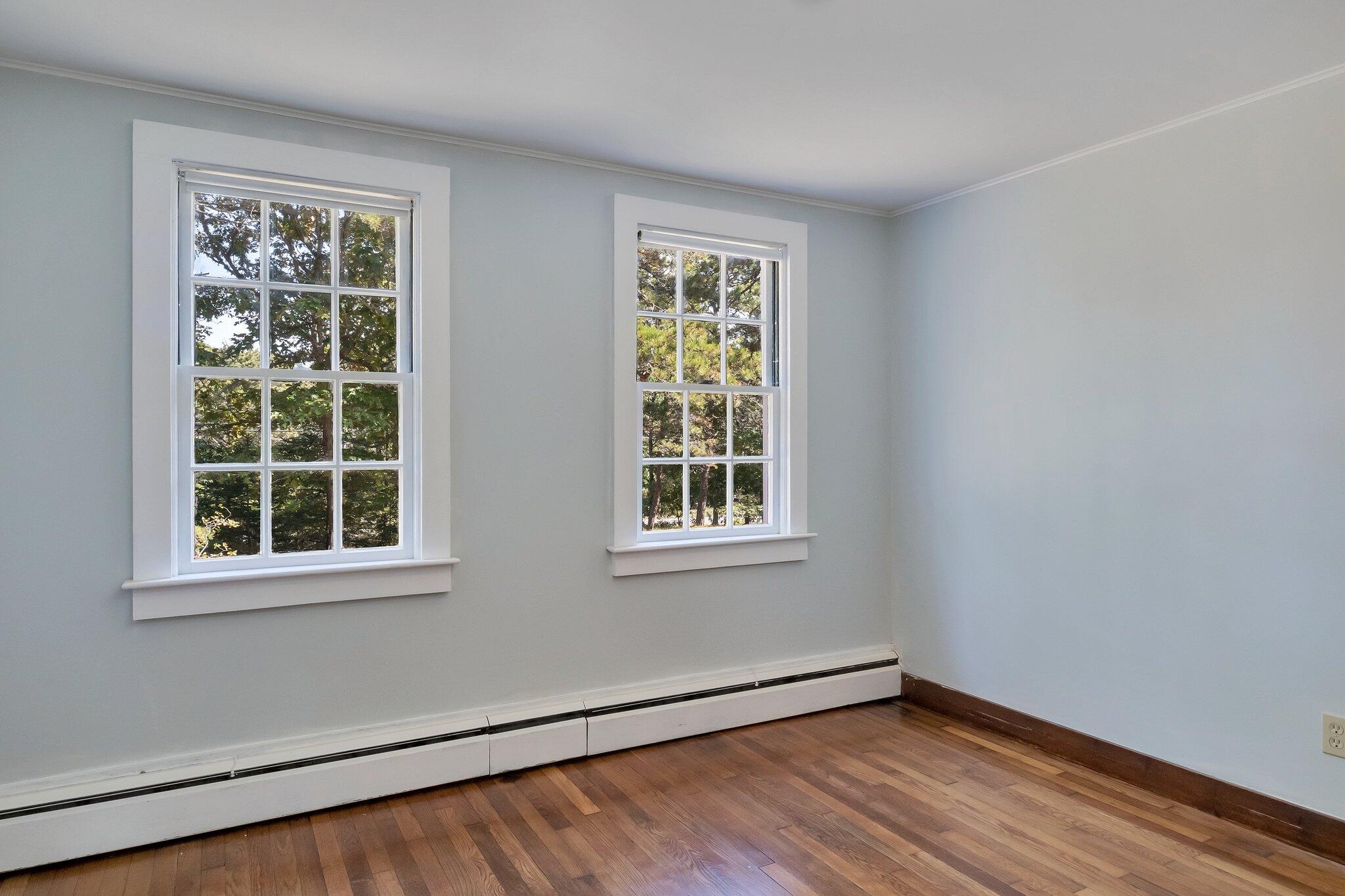 107 Chatham Road Harwich, MA 02645 - Photo 8 of 29 a view of an empty room with wooden floor and a window