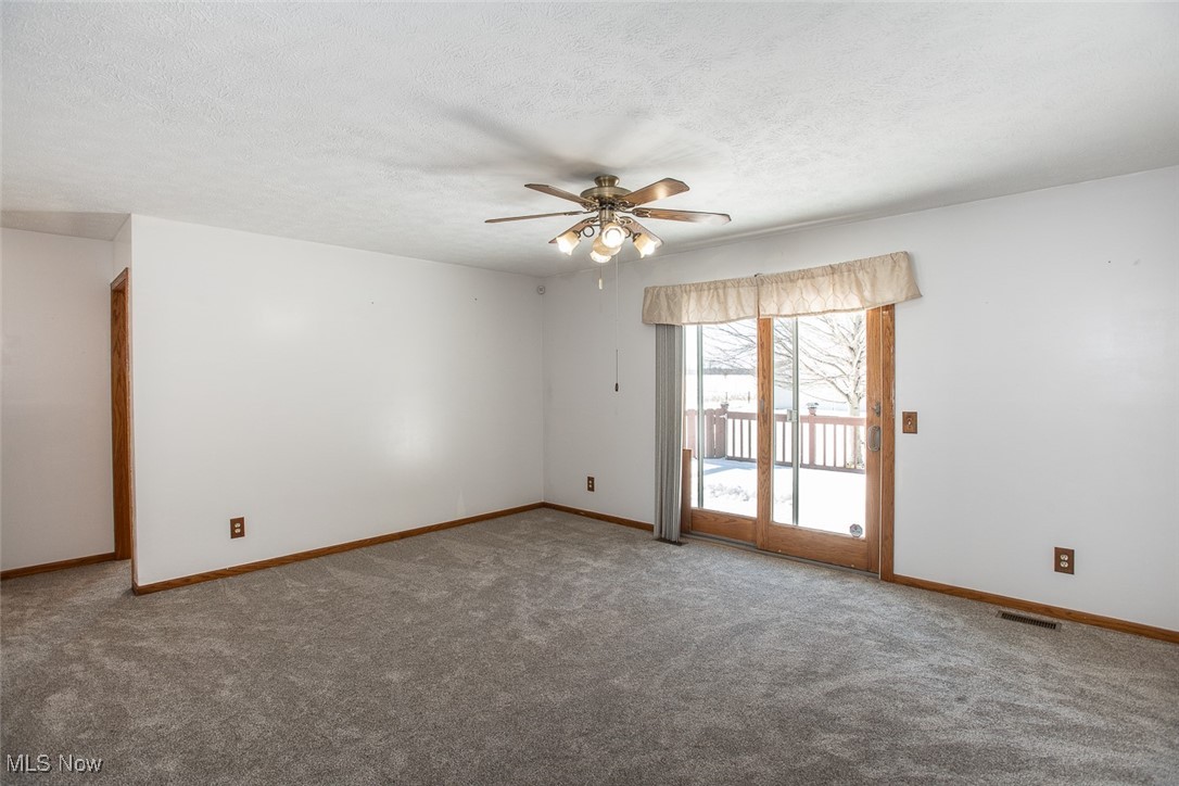 2624 Lester Road Medina, OH 44256 - Photo 19 of 50 Family Room or Dining Room with newer carpet, slider out to composite deck , rear yard and outbuilding
