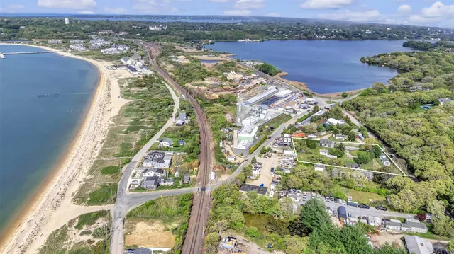 an aerial view of residential houses with outdoor space and river