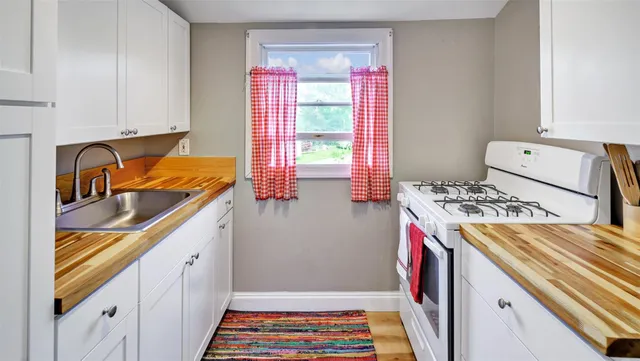 a storage room with wooden floor washer and dryer