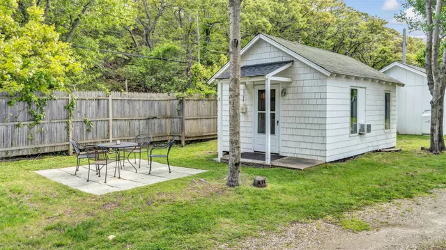 a view of a chair and table in backyard