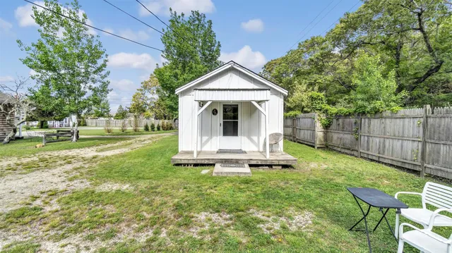 a view of a house with backyard and sitting area
