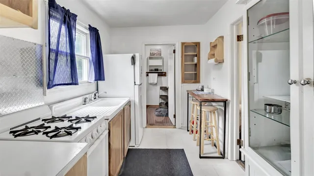 a kitchen with a sink stove and refrigerator
