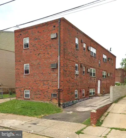 a tall brick building with a street sign on it