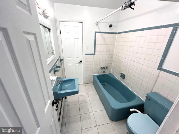 a bathroom with a toilet bathtub and sink