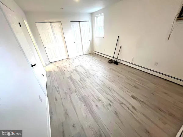 a view of a room with wooden floor and stairs