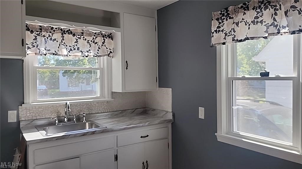 23621 Colbourne Road Euclid, OH 44123 - Photo 31 of 45 Kitchen featuring white cabinets and sink