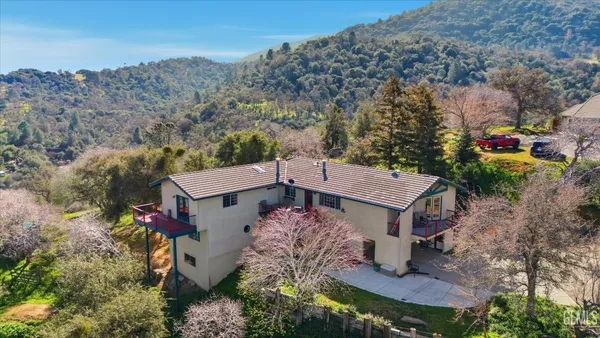 an aerial view of a house with a yard