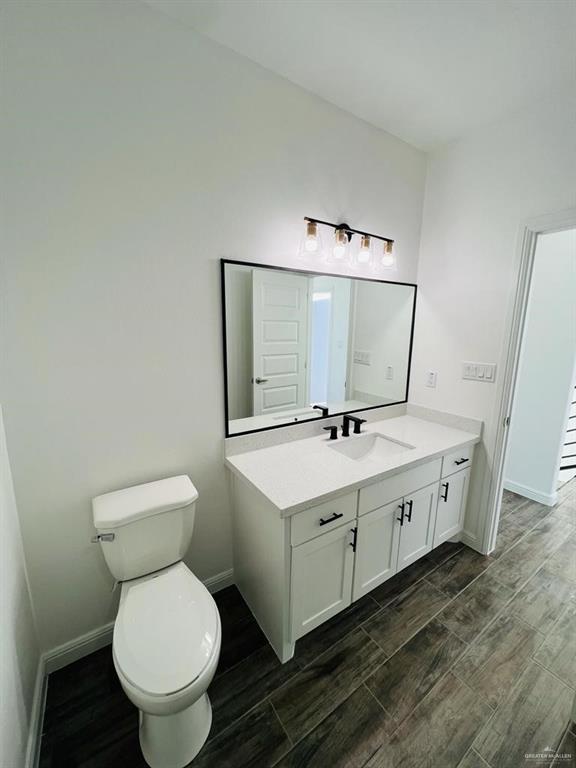 5403 North Crown Point Pharr, TX 78577 - Photo 16 of 30 a bathroom with a toilet sink and mirror
