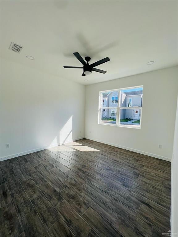 5403 North Crown Point Pharr, TX 78577 - Photo 20 of 30 an empty room with wooden floor and ceiling fan