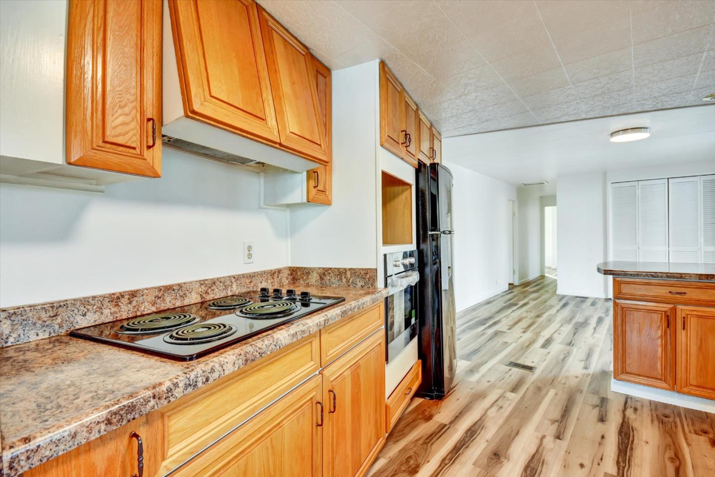 17 Pepperwood Way, Unit 17 Soquel, CA 95073 - Photo 12 of 56 a kitchen with stainless steel appliances granite countertop a stove and a sink