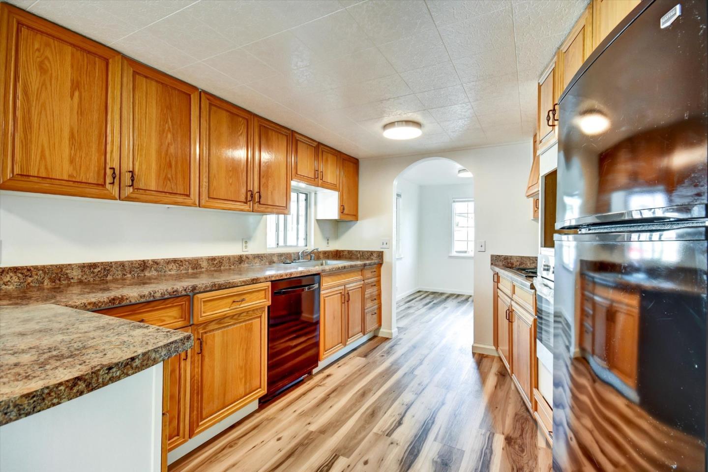 17 Pepperwood Way, Unit 17 Soquel, CA 95073 - Photo 13 of 56 a kitchen with stainless steel appliances granite countertop a stove a sink dishwasher and a refrigerator