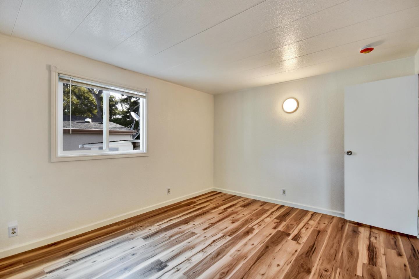 17 Pepperwood Way, Unit 17 Soquel, CA 95073 - Photo 24 of 56 a view of empty room with wooden floor and fan