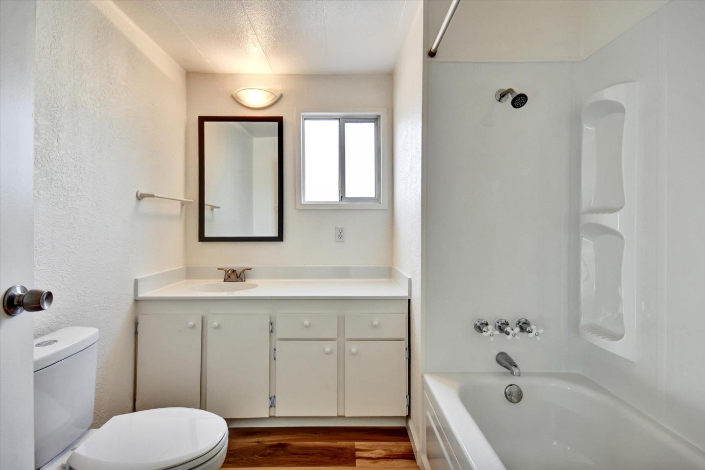 17 Pepperwood Way, Unit 17 Soquel, CA 95073 - Photo 26 of 56 a bathroom with a toilet sink vanity tub and mirror