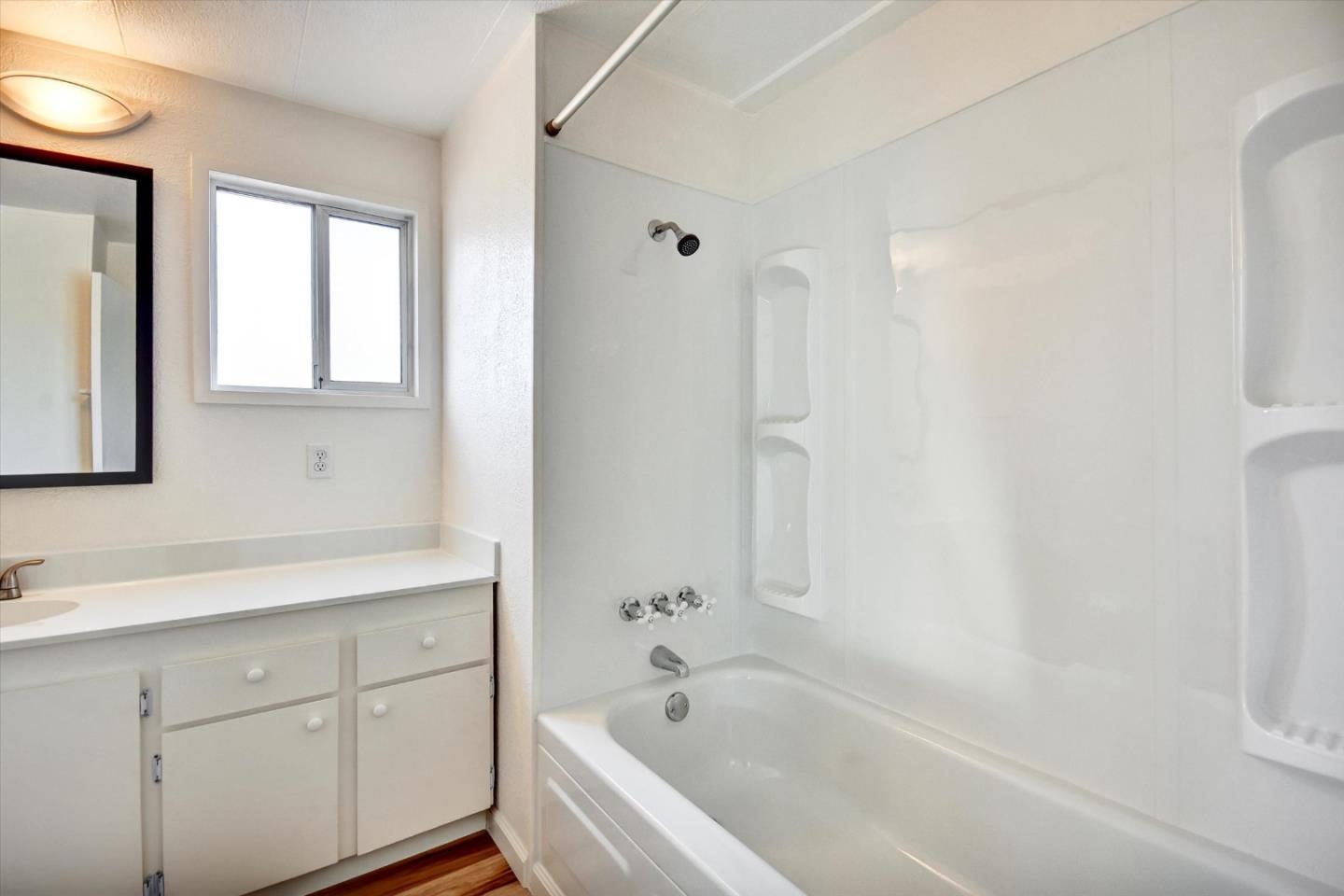 17 Pepperwood Way, Unit 17 Soquel, CA 95073 - Photo 27 of 56 a bathroom with a bathtub shower sink and mirror