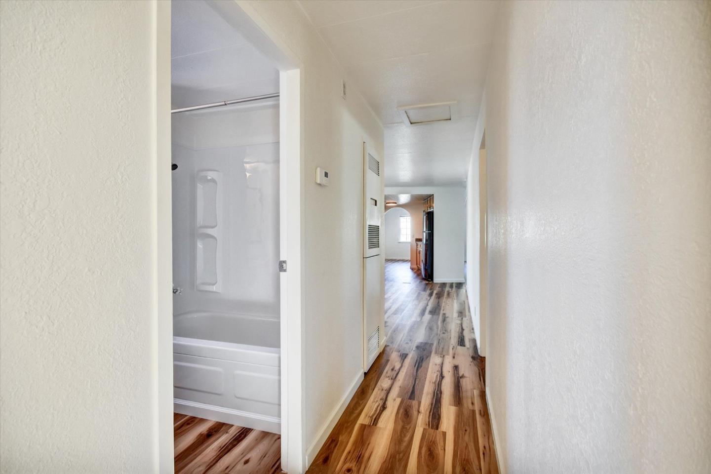 17 Pepperwood Way, Unit 17 Soquel, CA 95073 - Photo 44 of 56 a view of a hallway with wooden floor and a bathroom