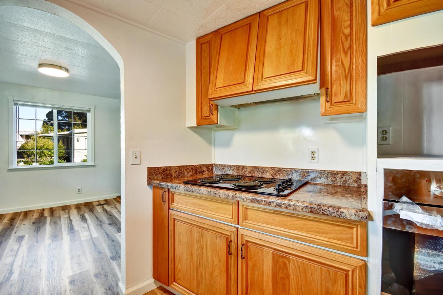 17 Pepperwood Way, Unit 17 Soquel, CA 95073 - Photo 47 of 56 a kitchen with granite countertop wooden cabinets and a stove top oven
