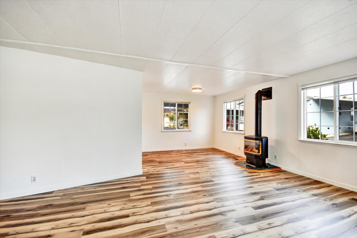 17 Pepperwood Way, Unit 17 Soquel, CA 95073 - Photo 7 of 56 an empty room with wooden floor and windows