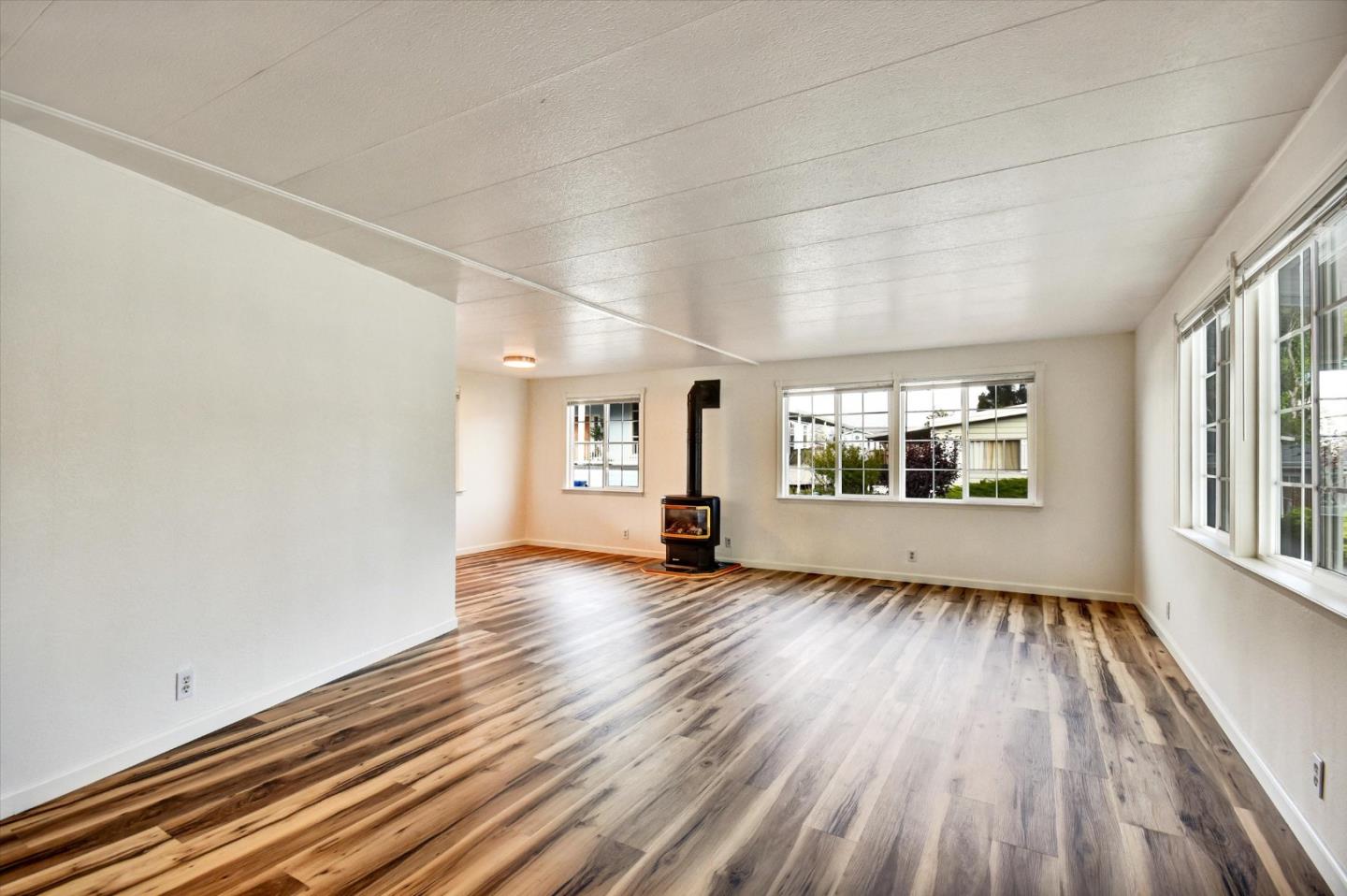 17 Pepperwood Way, Unit 17 Soquel, CA 95073 - Photo 8 of 56 wooden floor in an empty room with a window