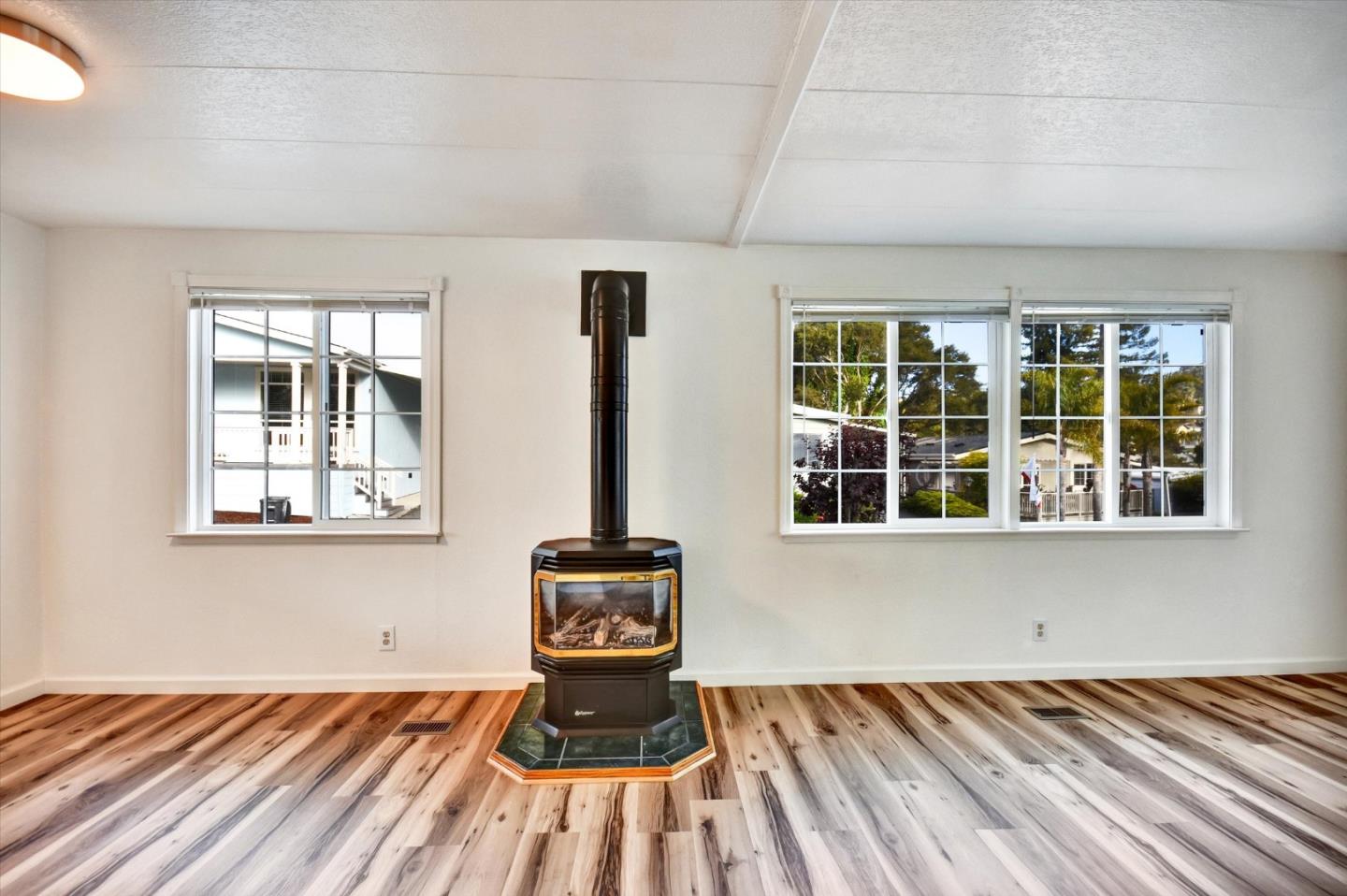 17 Pepperwood Way, Unit 17 Soquel, CA 95073 - Photo 10 of 56 a view of an empty room with wooden floor and a window